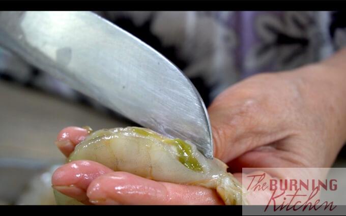 Deveining prawn with knife
