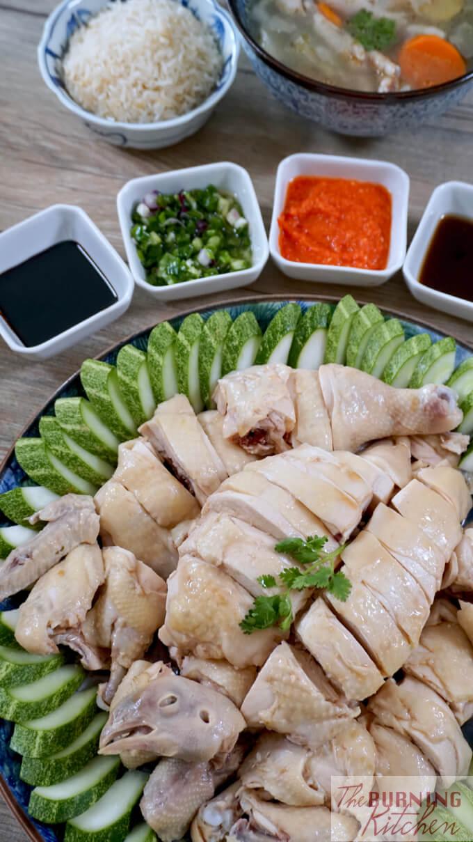 Singapore style hainanese chicken rice with accompanying sauces and chicken soup