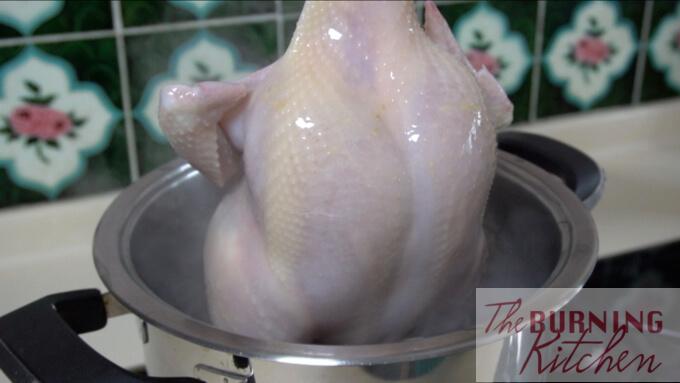 pulling the chicken out of boiling water