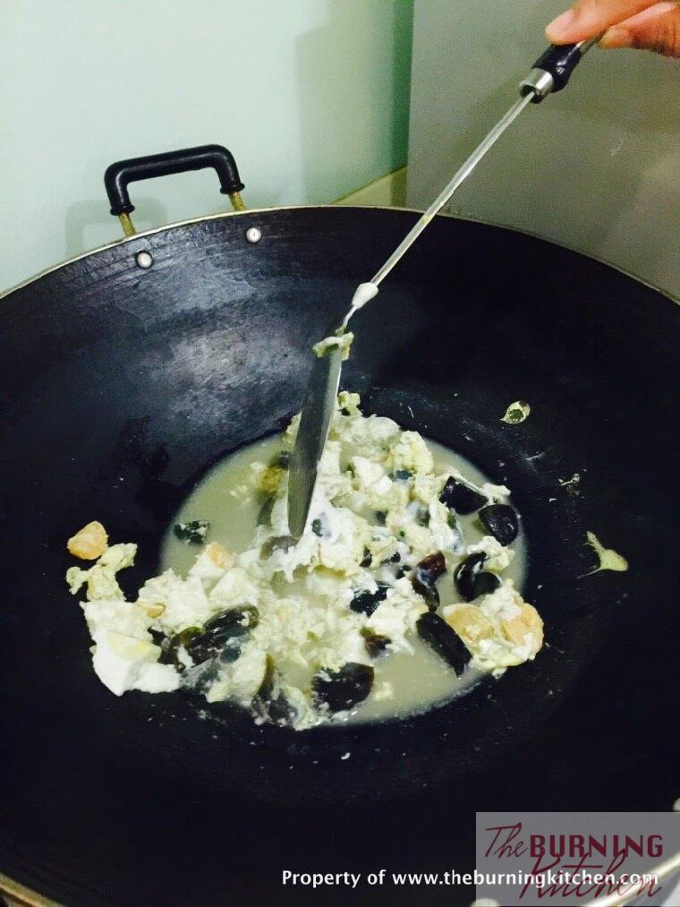 stiring mixture with 3 kinds of eggs in wok