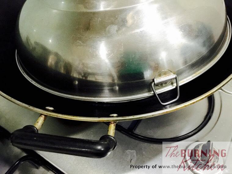 Wok covered but ensure a small gap to allow steam to escape