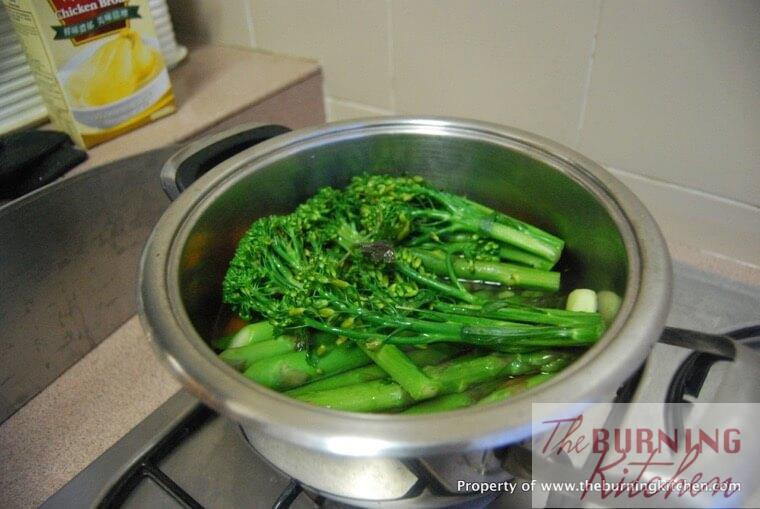 Boiling broccolini in metal pot
