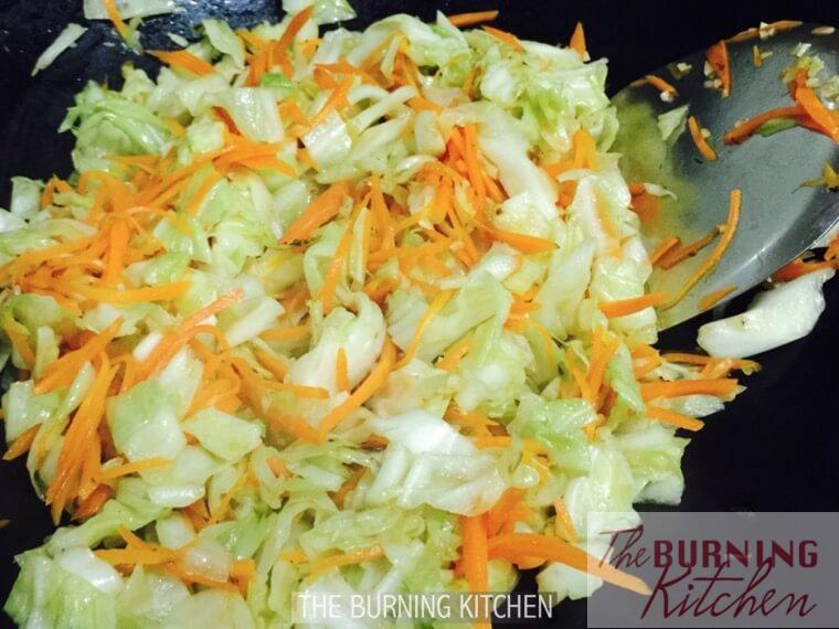 Frying shredded carrot and cabbage in wok