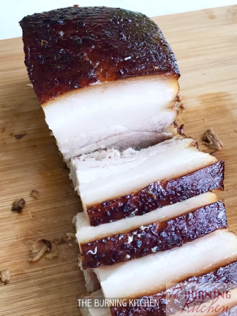 Cut braised pork belly slices on wooden board 
