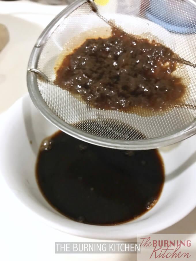 Filtering marinade through sieve to get rid of scum