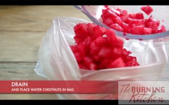 Putting dyed red water chestnuts in bag