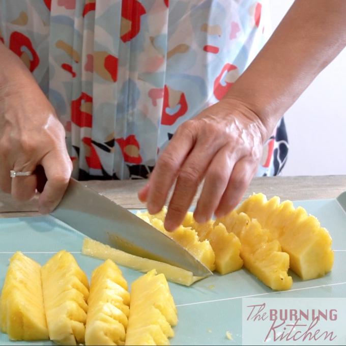 Cutting pineapple into chunks