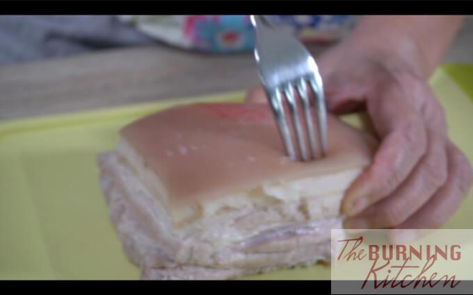 Poking pork belly skin with a fork 