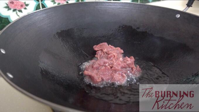 Frying sliced beef in wok