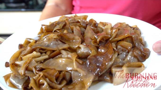 Stir fried flat noodles (hor fun) in a white plate
