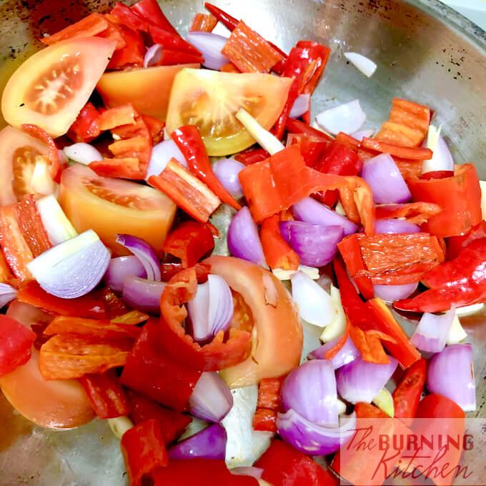 Tomatoes, chillis and shallots in a pan