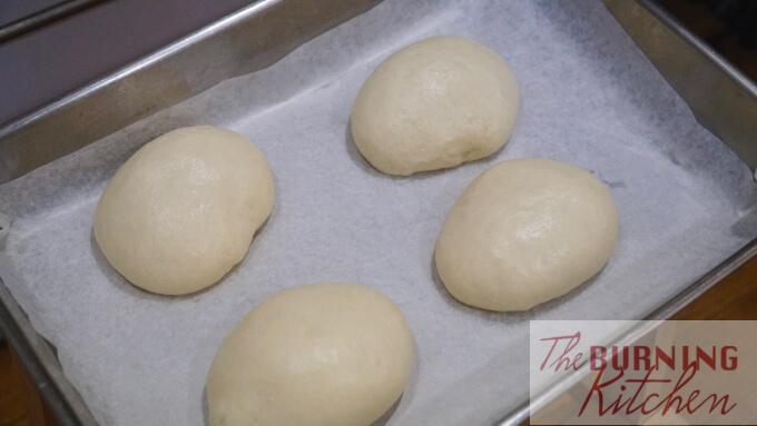 dough balls doubling in size in baking tray